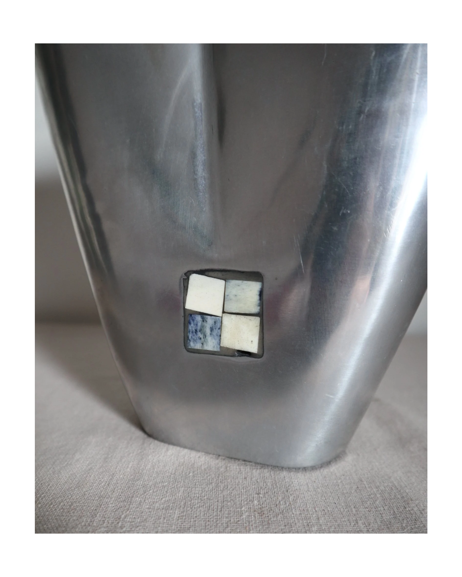 Postmodern heavy cast aluminium vase with sculptural form and four small inset stones. In the style of Anna Efverlund. Circa 1980s. Unsigned.