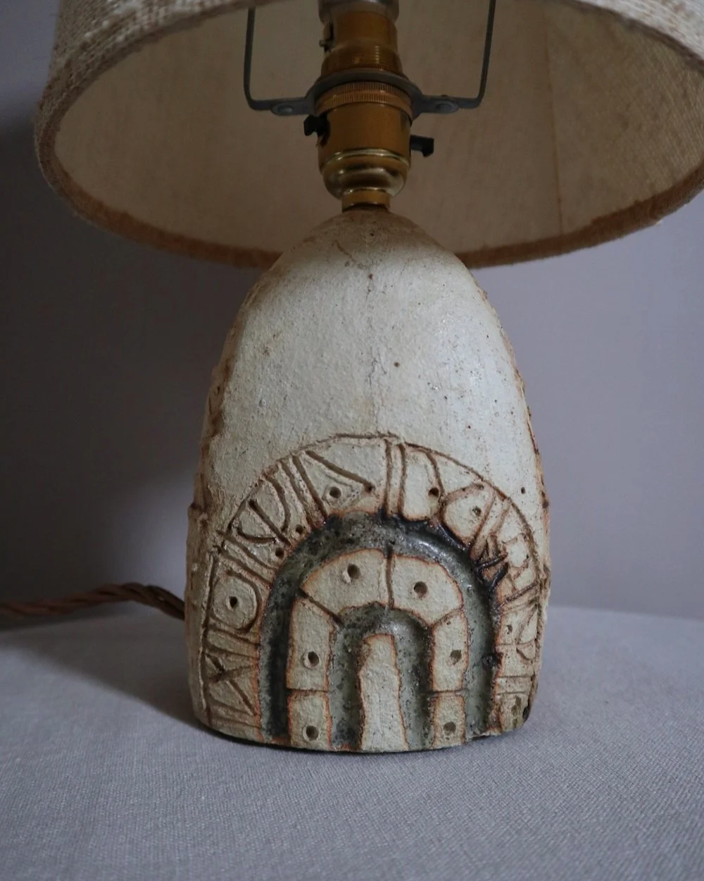 Small Brutalist stoneware table lamp by British potter Bernard Rooke. With stamped, rune-like impressions. Circa 1970s.