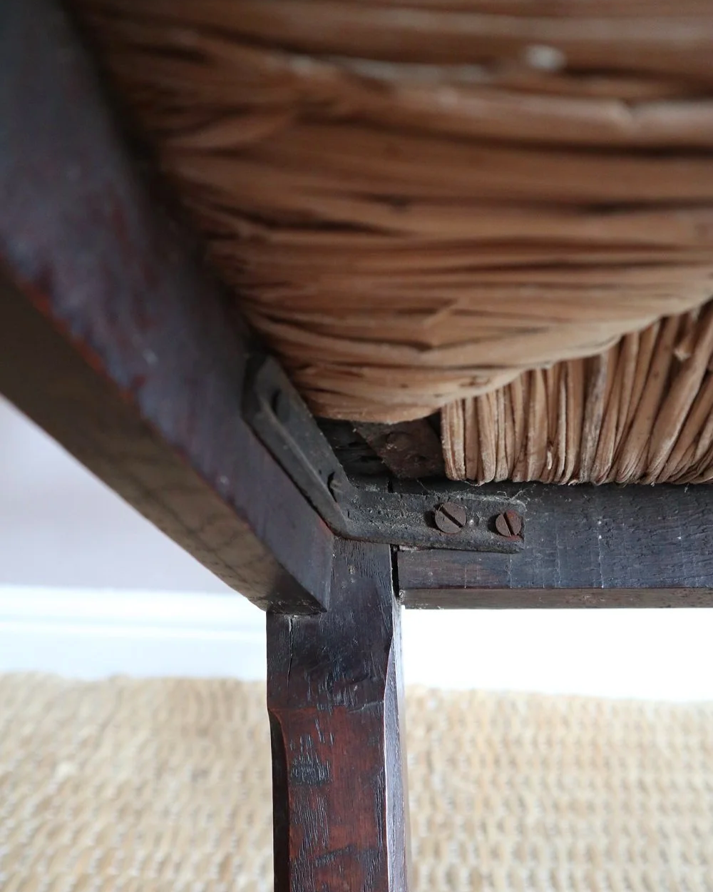 Pair of sculptural rustic oak ladder back dining chairs with rush seats, circa 1930s.