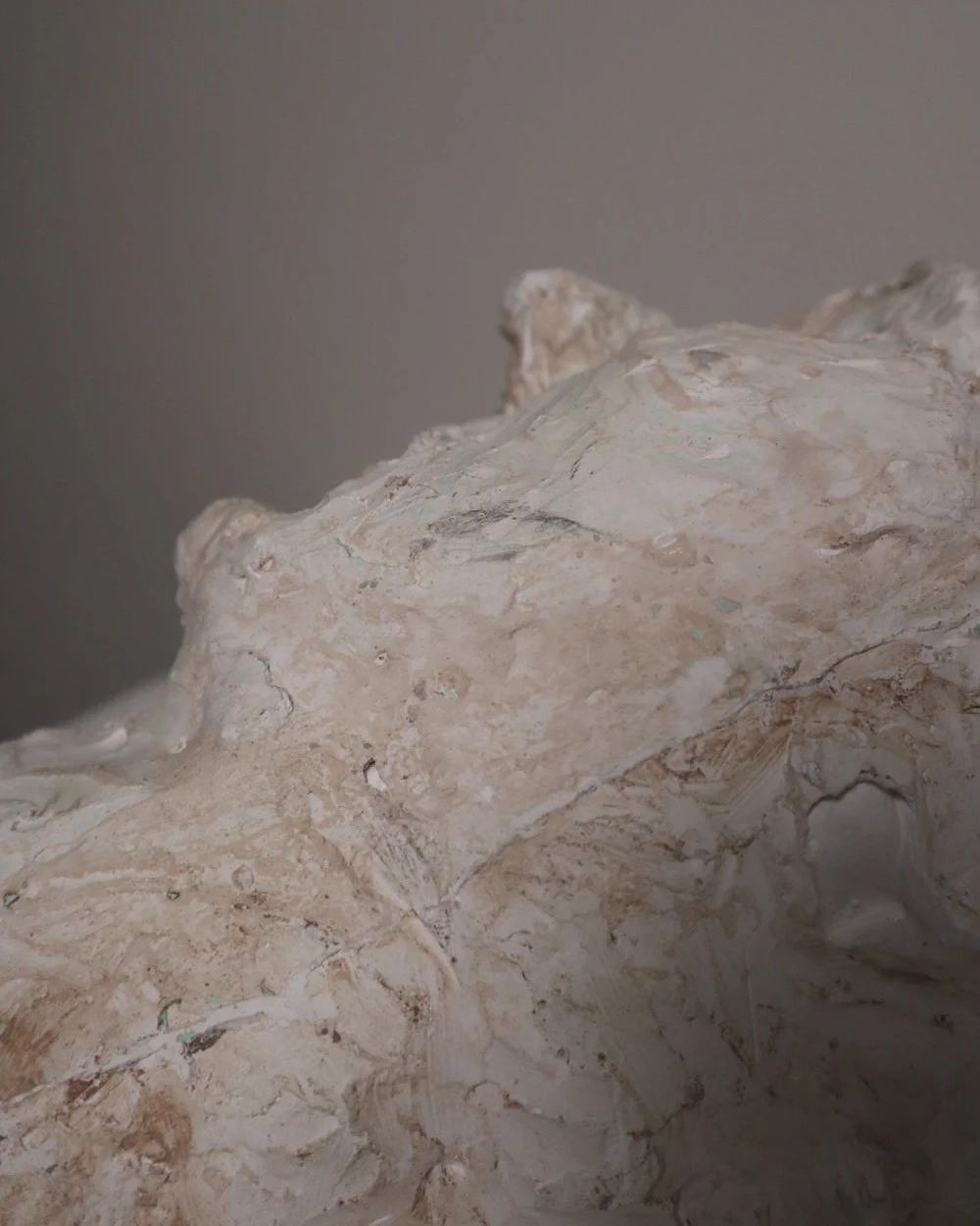 Large, heavy off white textured plaster sculpture of man's head in abstract style. Unknown age.