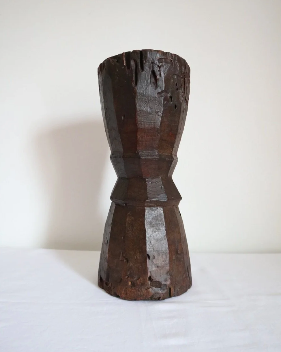 Heavy primitive sculptural carved wooden mortar with handle.