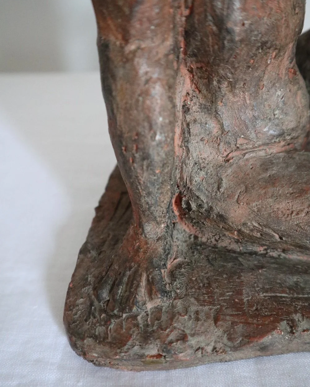 Heavy handmade studio pottery textured sculpture of seated nude woman.