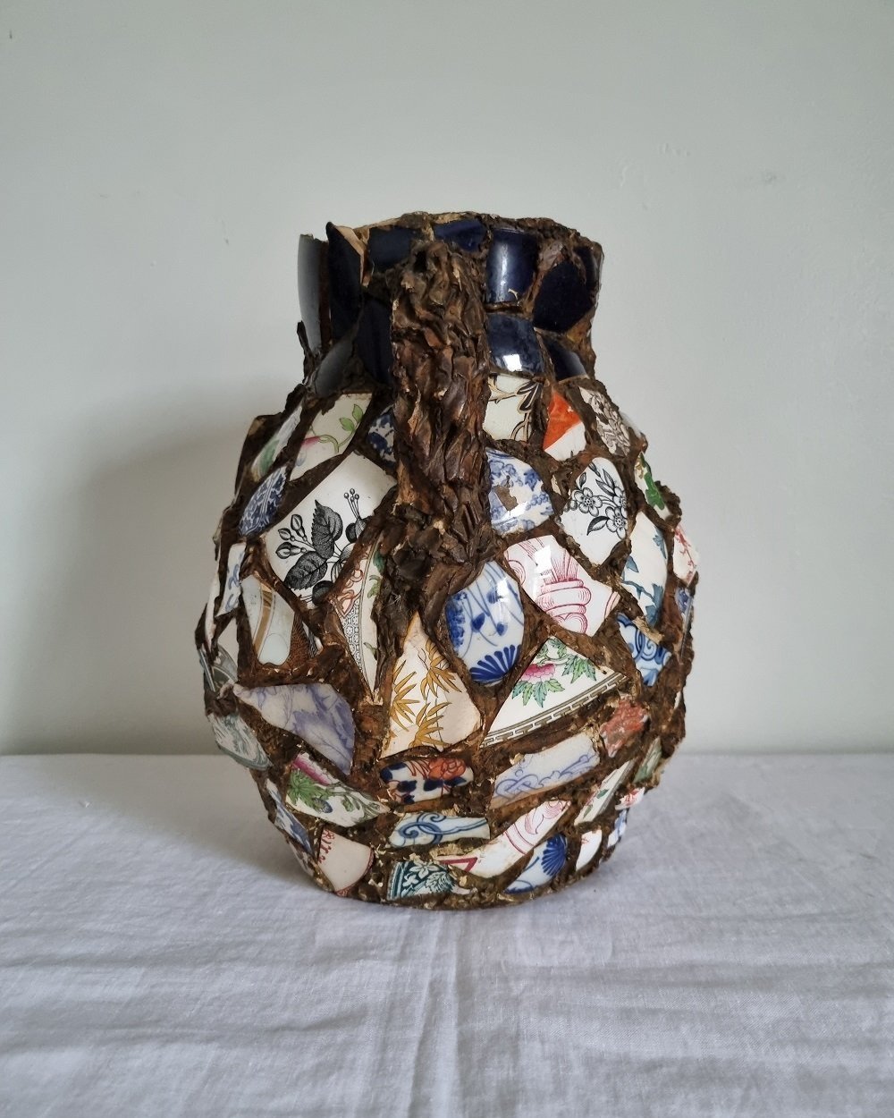 Large French pique assiette mosaic pottery jug with handle.