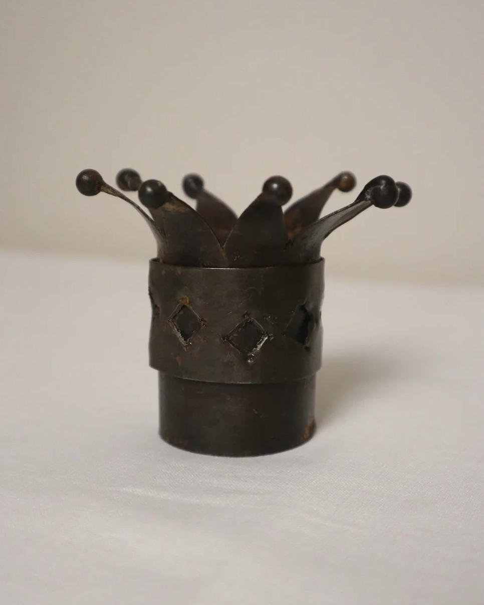 Pair of Modernist style, small dark metal jester hat or crown shaped tea light holders with diamond cut outs.