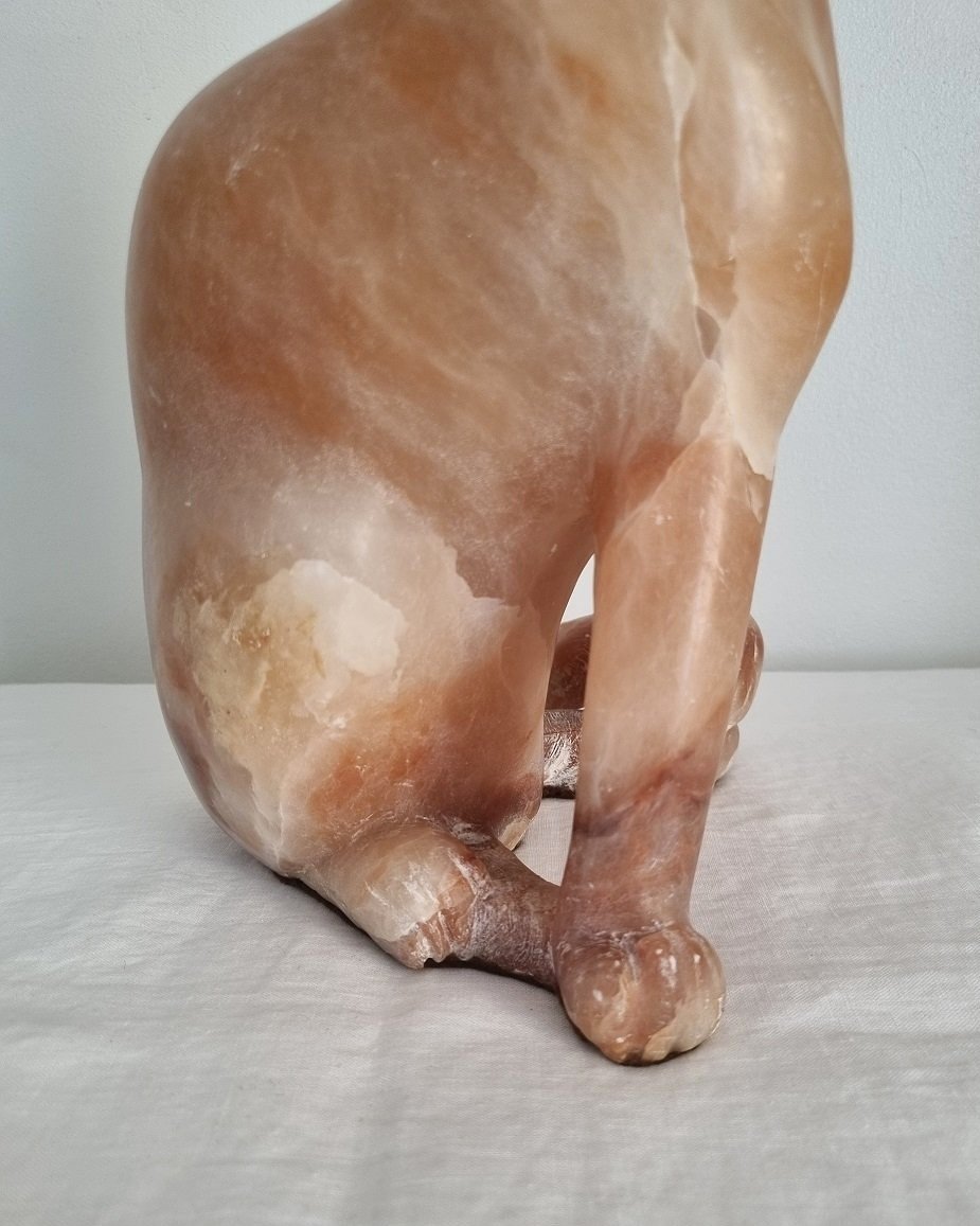 Vintage, heavy hand carved soft pink alabaster cat with striking natural grain and smooth lines.