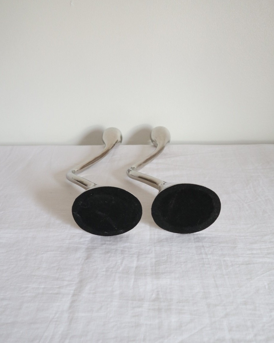 Pair of sculptural solid aluminium candleholders, circa 1970s.