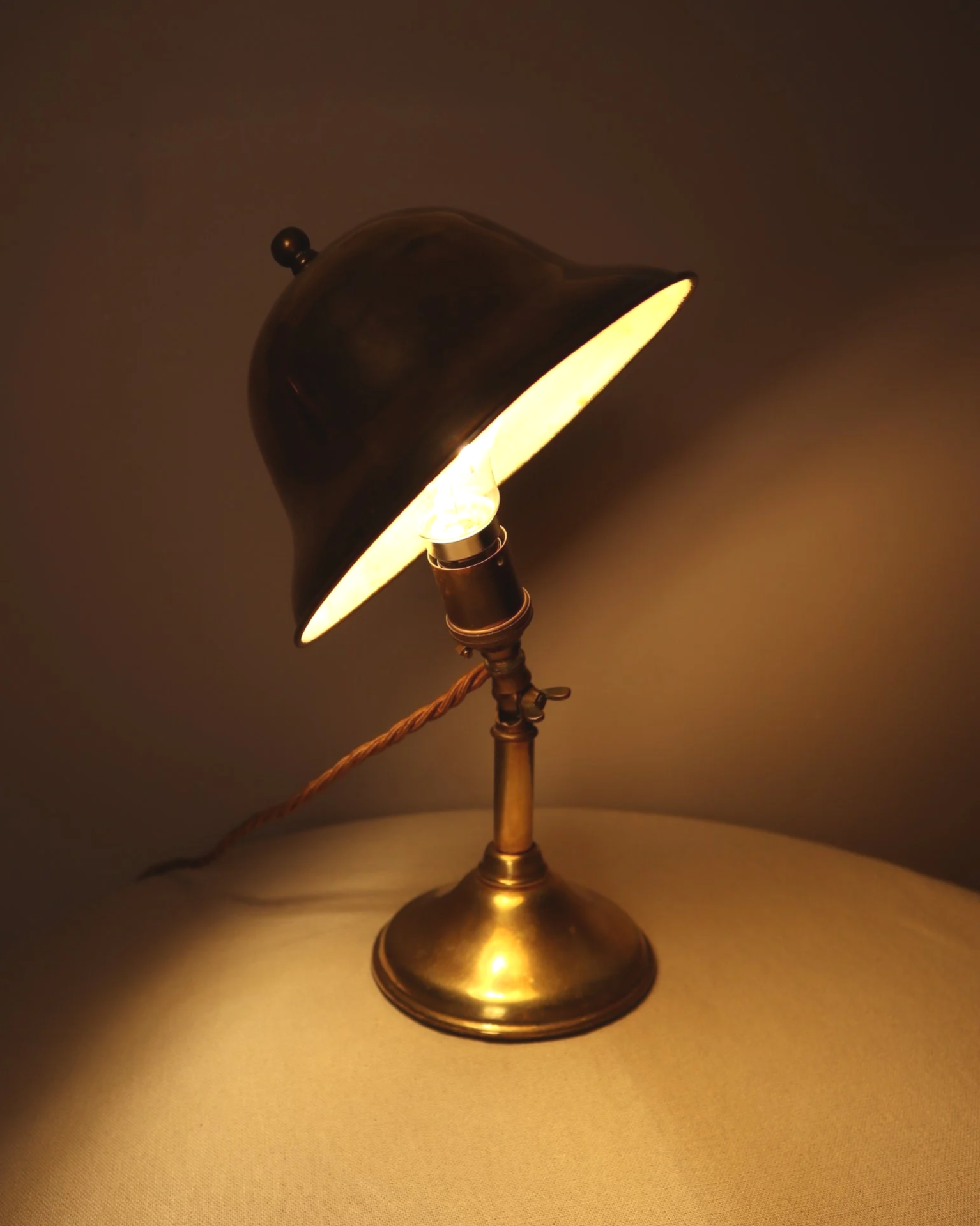 Small, vintage adjustable brass worker's desk lamp. Can be freestanding or attached to the edge of a workbench etc with clamp.