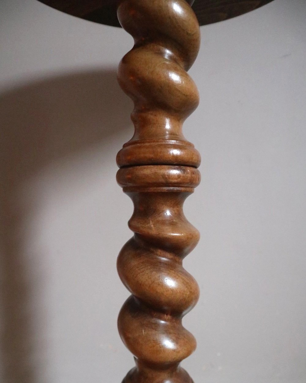 French barley twist circular wooden side table with three round feet.