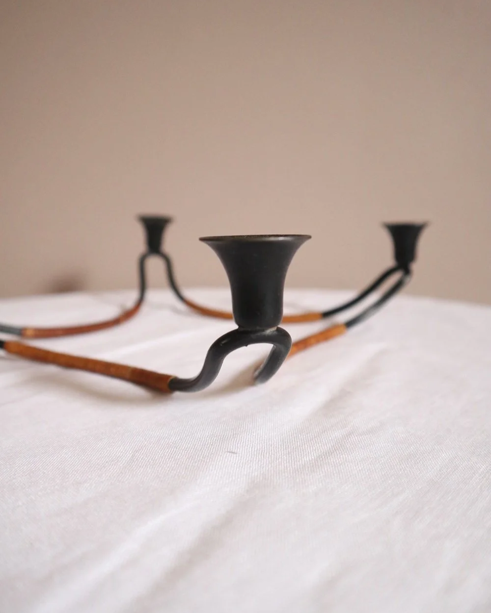 Modernist Danish iron and woven rattan four candle holder designed by Laurids Lønborg. Circa 1950s.