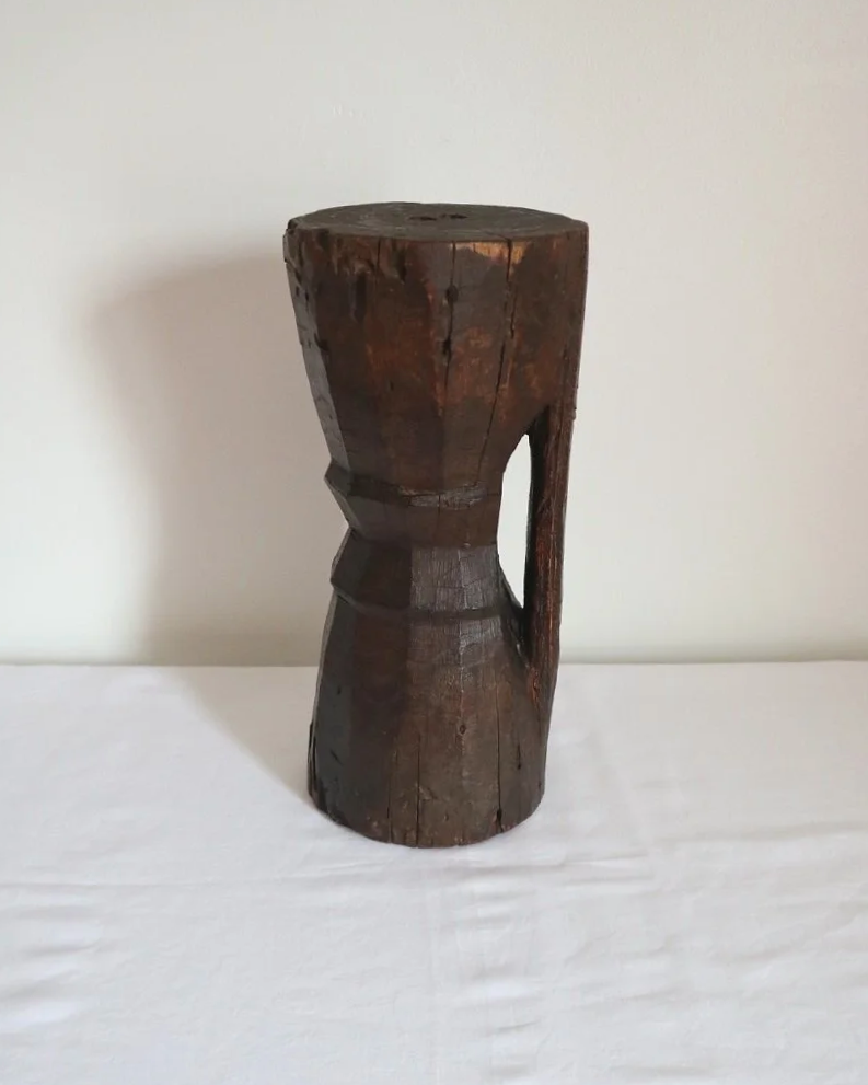 Heavy primitive sculptural carved wooden mortar with handle.
