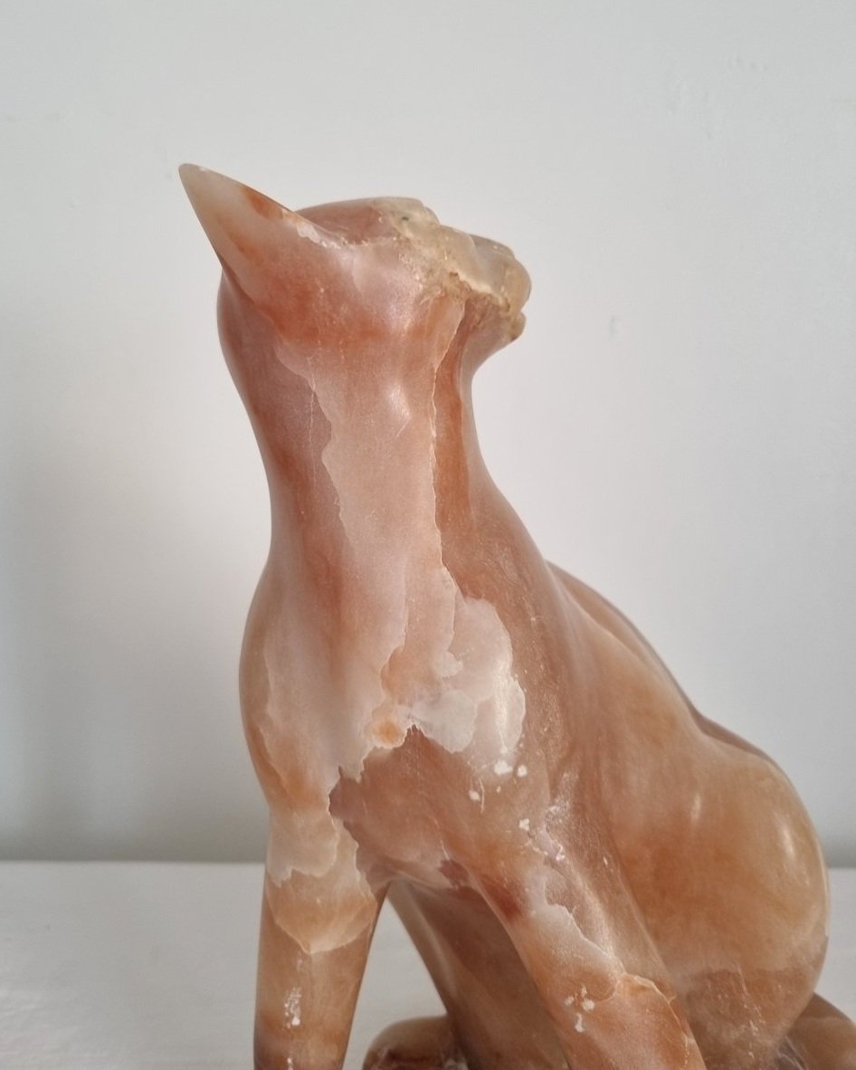 Vintage, heavy hand carved soft pink alabaster cat with striking natural grain and smooth lines.