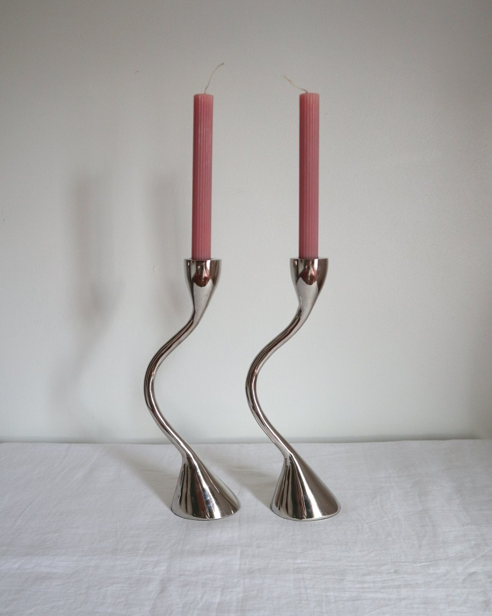 Pair of sculptural solid aluminium candleholders, circa 1970s.