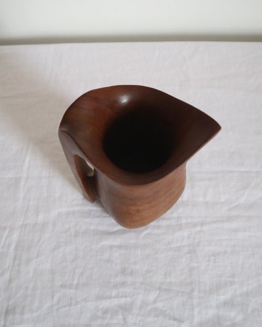 Small sculptural hand carved dark olivewood monoxyl pitcher, circa 1960/70s. In the manner of Alexandre Noll. Unsigned.