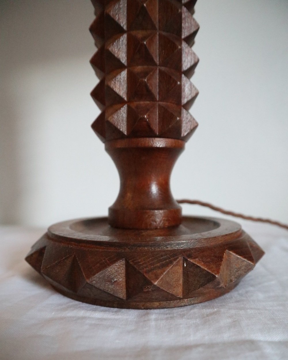French Charles Dudouyt style carved wooden Brutalist table lamp with new, white pleated lampshade.
