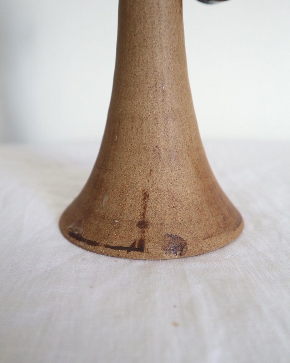 Rustic handmade studio pottery sculptural candleholder with curled circular handle.