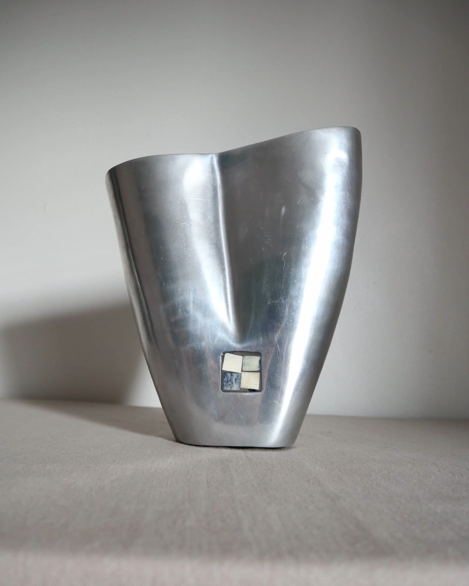 Postmodern heavy cast aluminium vase with sculptural form and four small inset stones. In the style of Anna Efverlund. Circa 1980s. Unsigned.