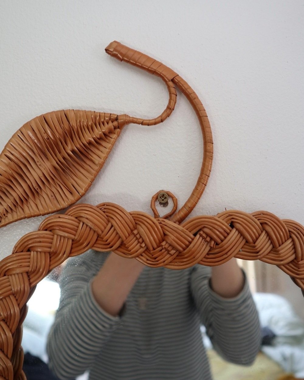 Pair of vintage small wall mirrors in the shape of an apple and a pear, with woven wicker frames.