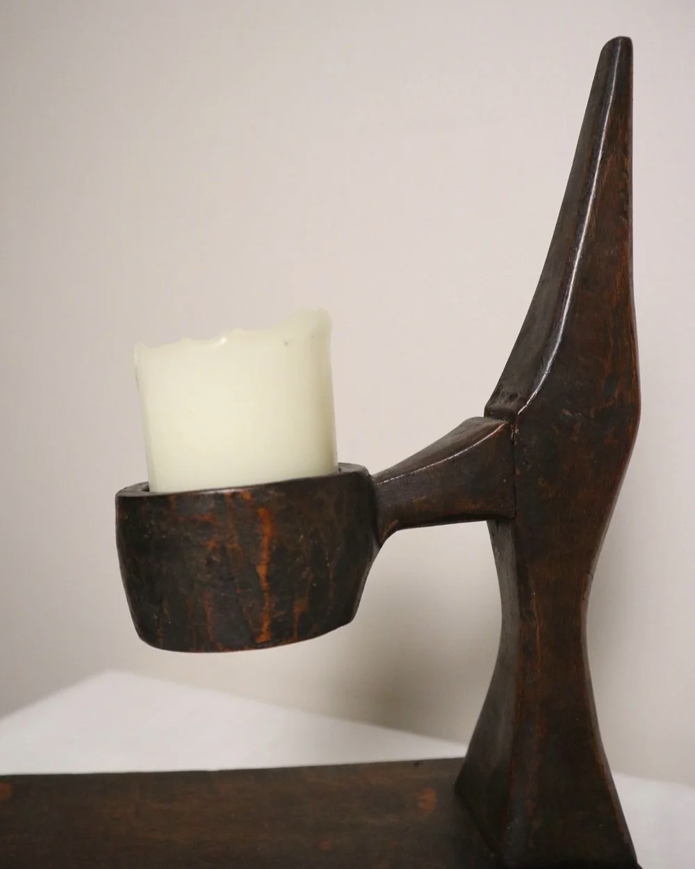 American hand carved dark wooden Brutalist candleholder with block base.