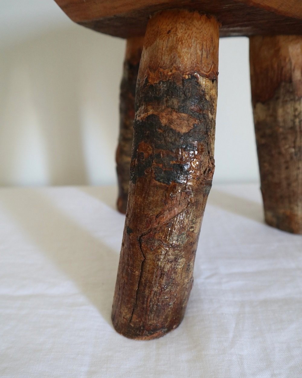Vintage small rustic folk art handmade wooden stool from Fenterleigh Woodcraft, Tintagel Cornwall, Circa 1940s.