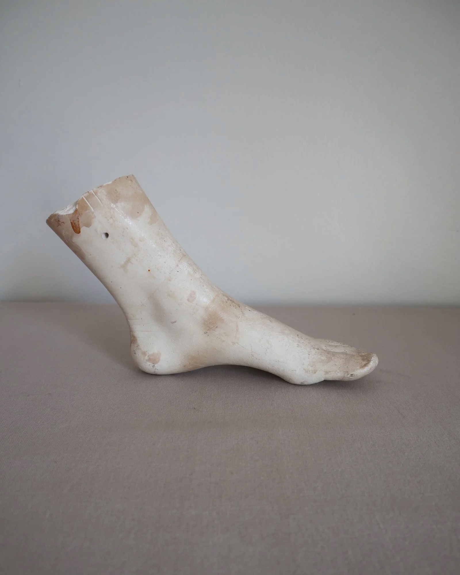 Classical-style decorative plaster foot sculpture, likely used as an anatomical or art studio study model.