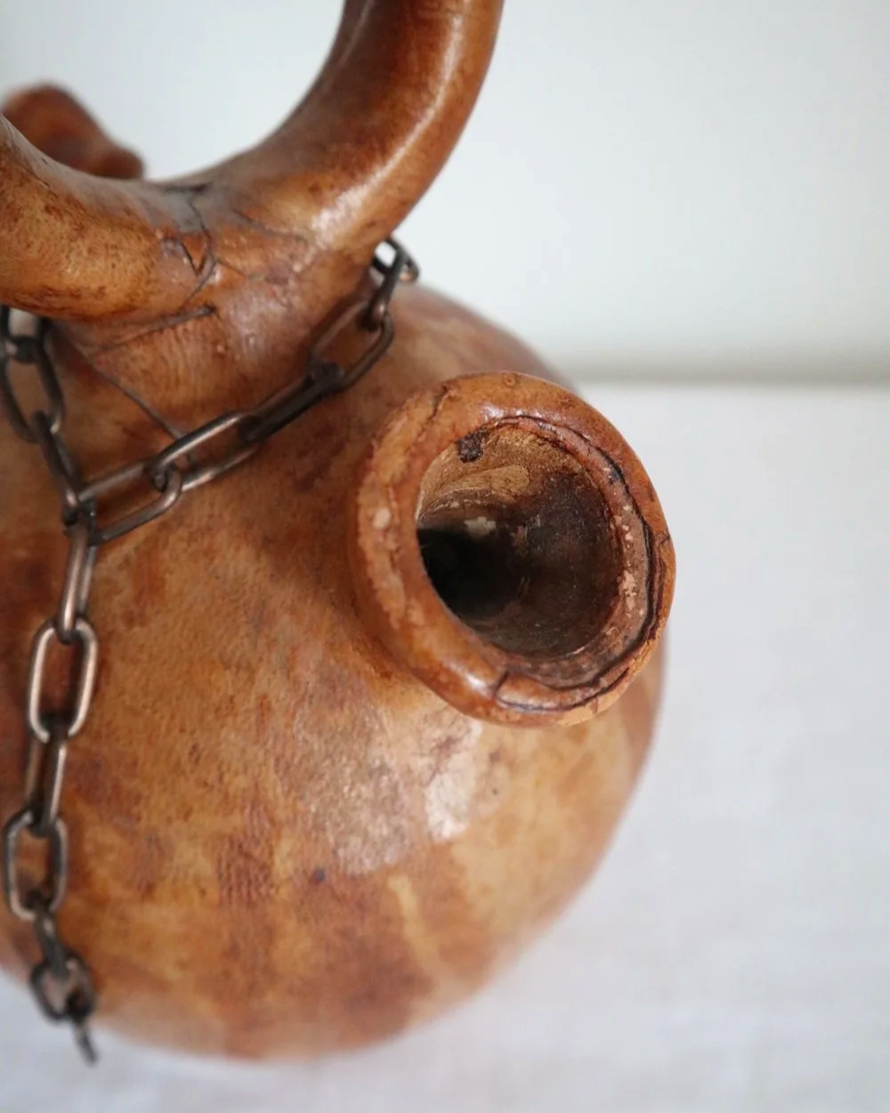 Spanish distressed tan leather covered oil or water pourer.