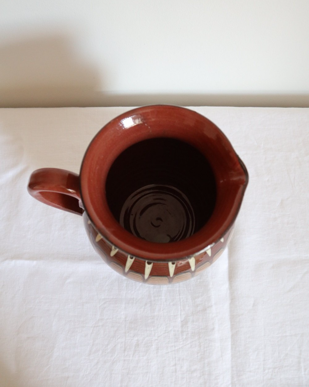 Large Bulgarian green and brown ceramic pitcher jug in traditional Troyan style.
