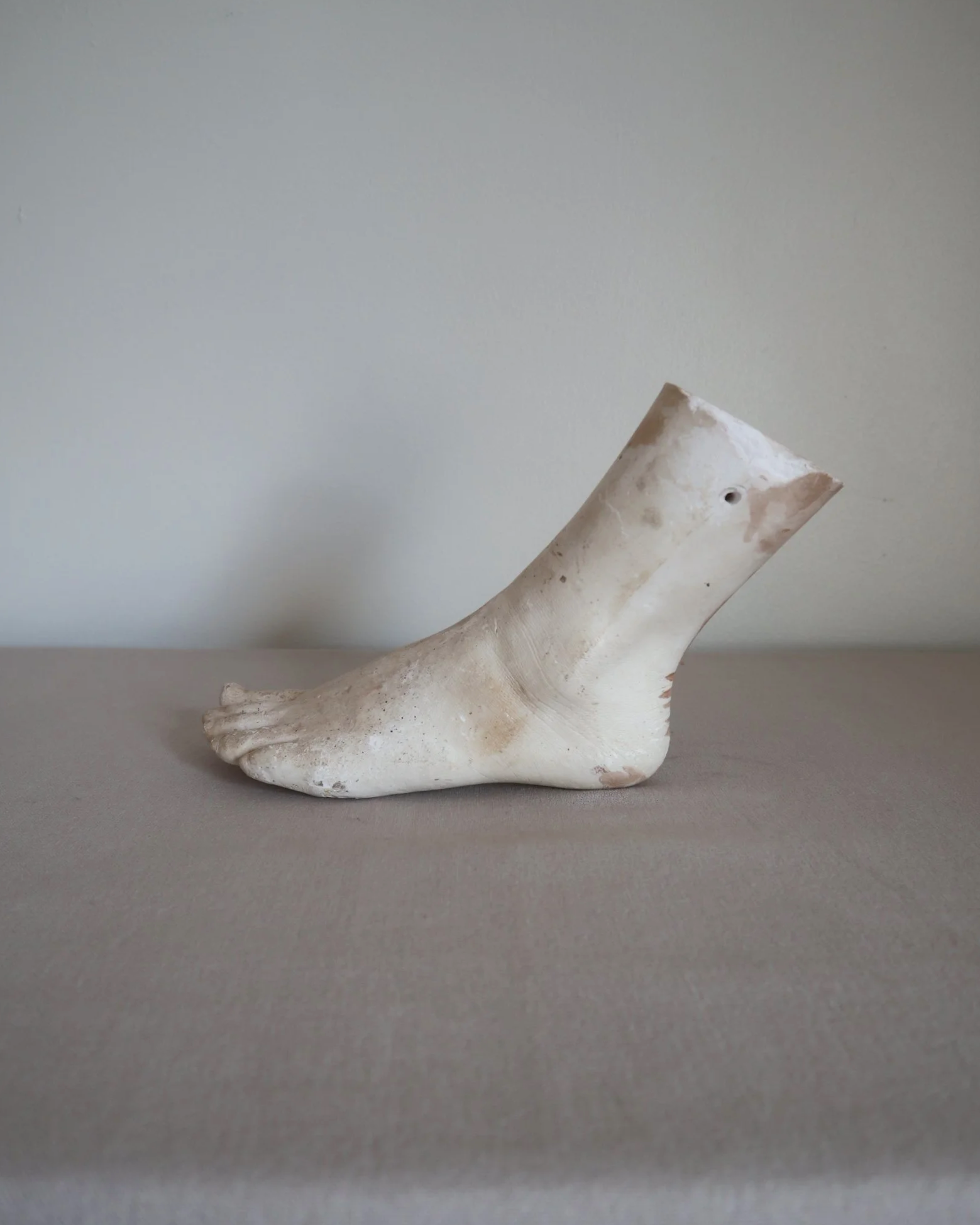 Classical-style decorative plaster foot sculpture, likely used as an anatomical or art studio study model.