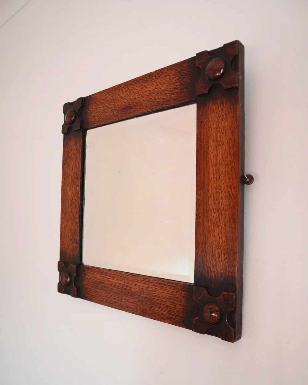 Arts & Crafts square wooden framed mirror with carved corner detailing. Circa 1930s.
