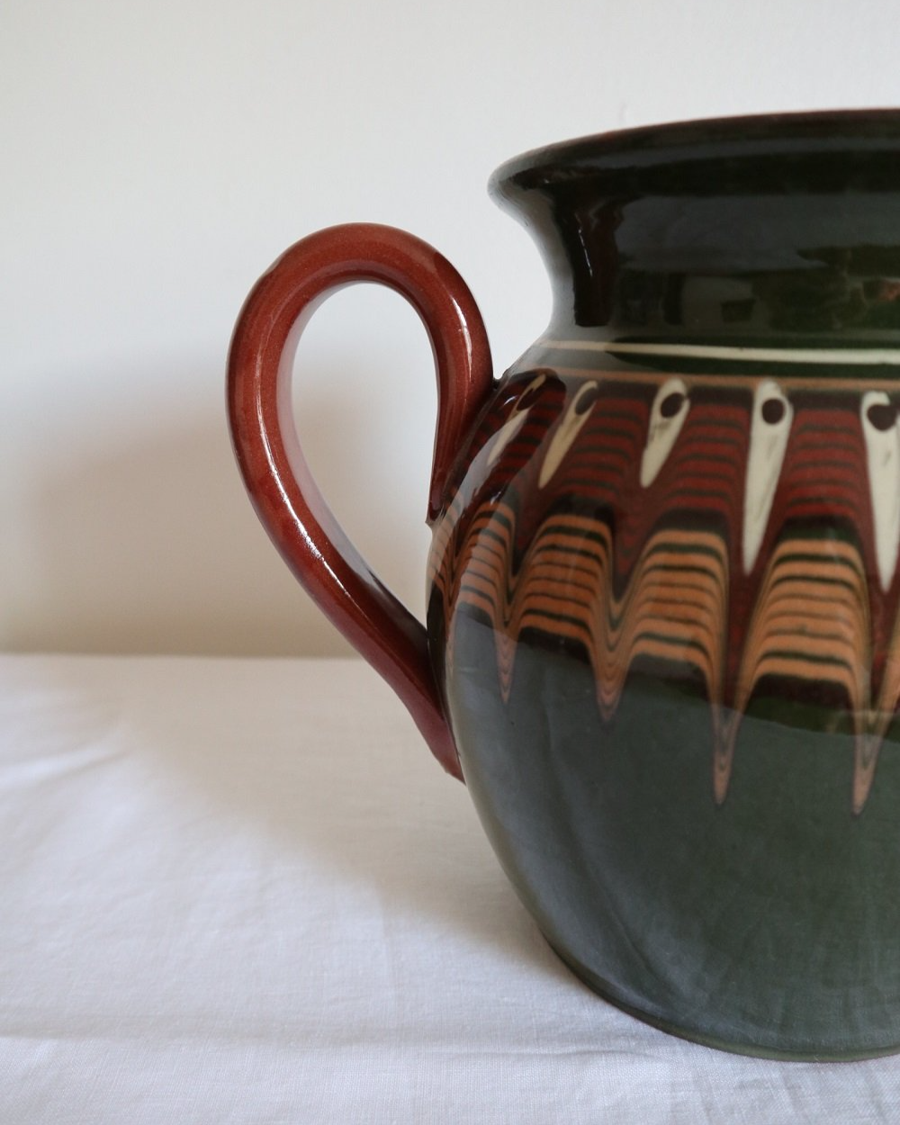 Large Bulgarian green and brown ceramic pitcher jug in traditional Troyan style.