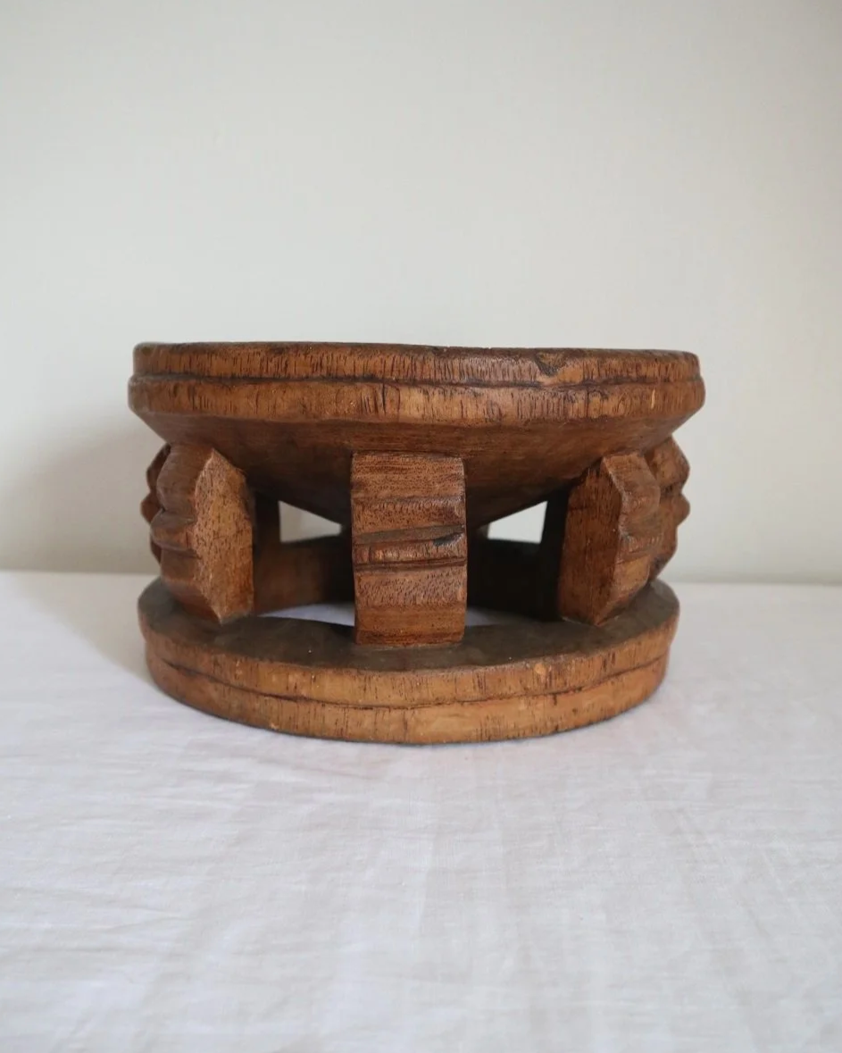 Vintage Nigerian small circular low stool carved from one piece of wood with decorative etchings to surface.