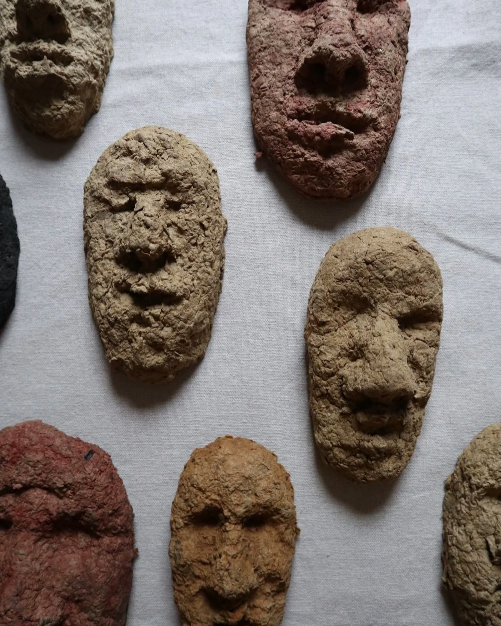 Set of unique handmade textured papier mache faces in earthy tones. Unknown age.  Unknown artist.