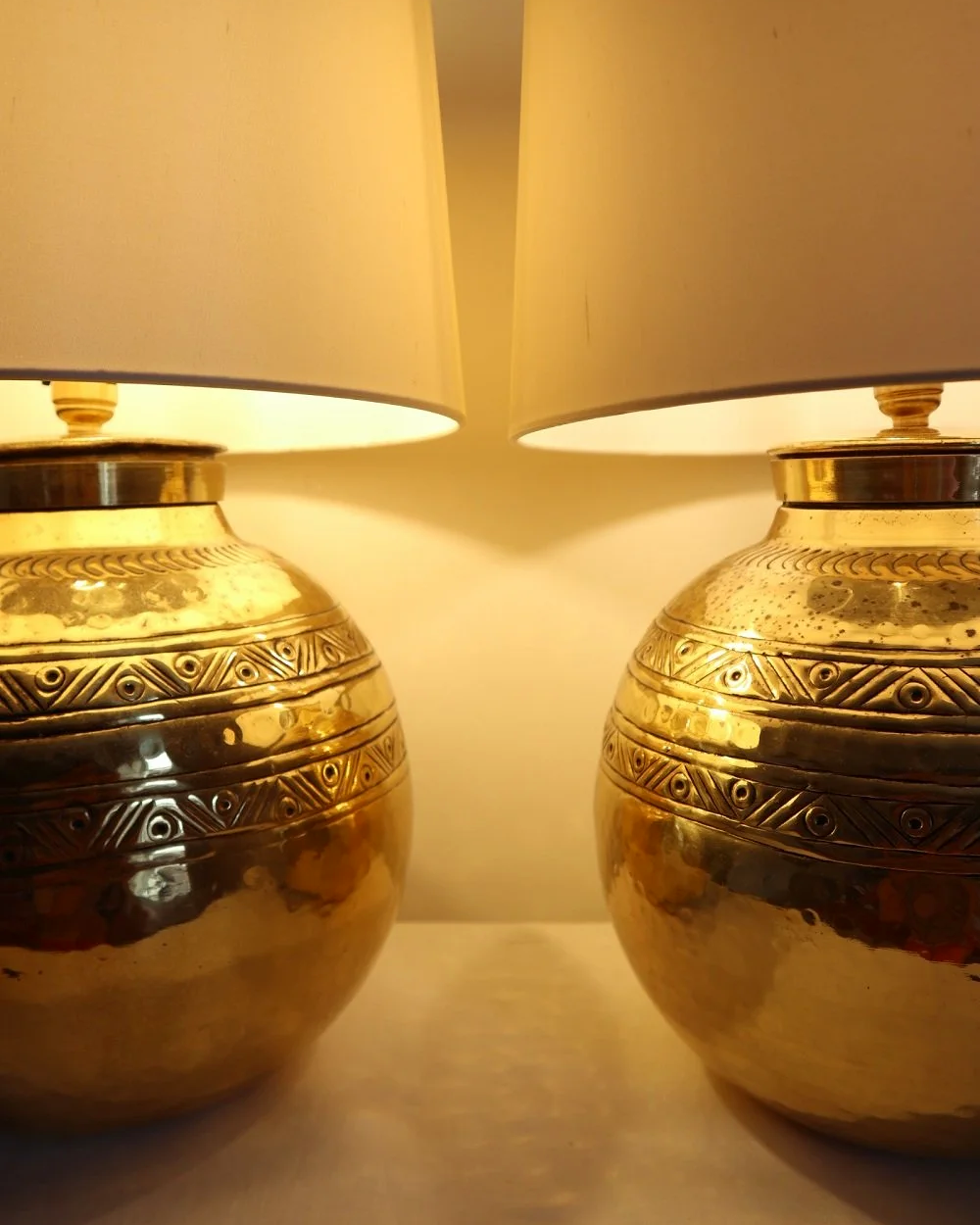 Pair of large, vintage beaten brass spherical table lamps with etched decoration.