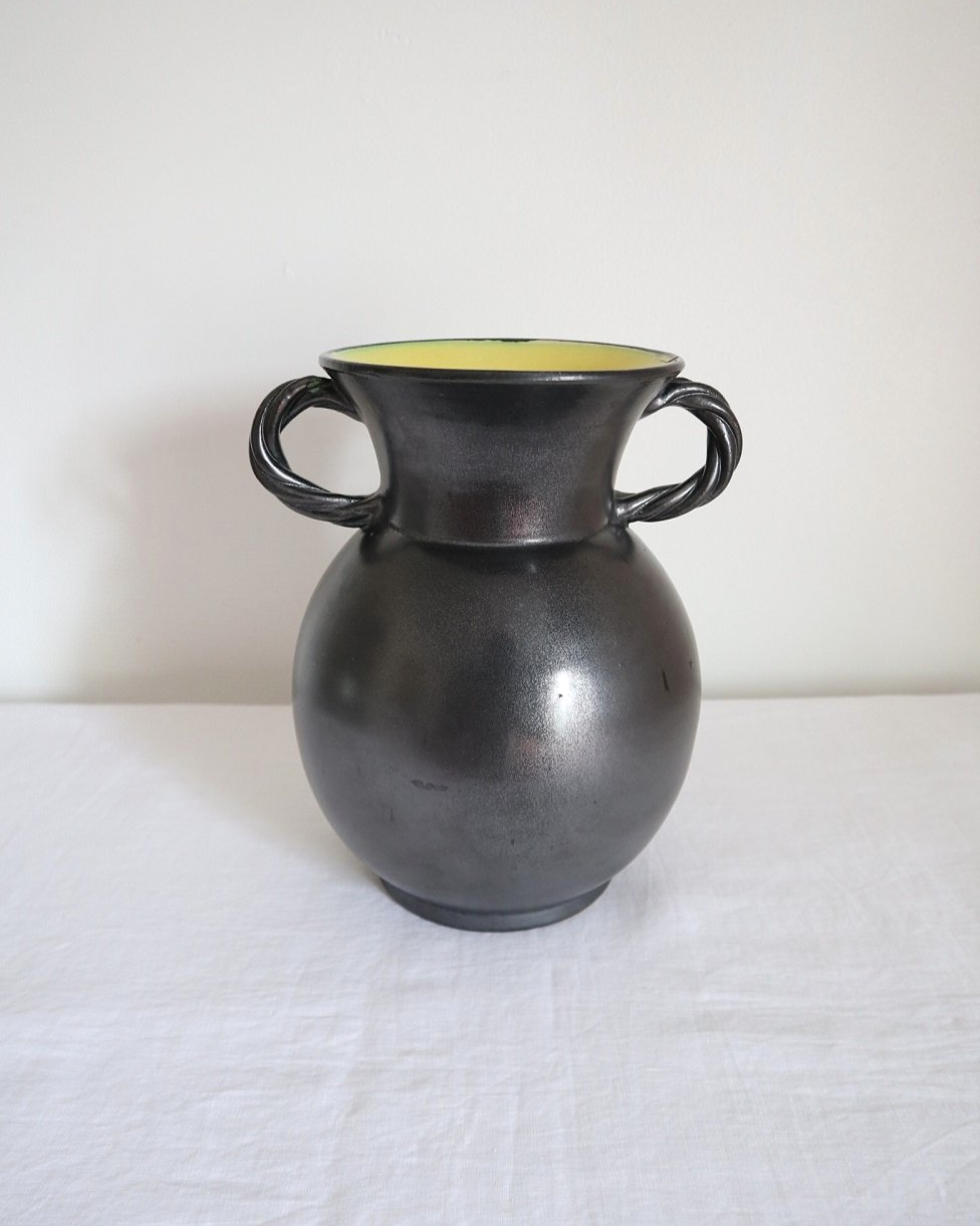 Large glossy, metallic black vase with double twisted handles and contrasting, yellow crackled glaze interior. Typical of Elchinger productions, France. Circa 1950s