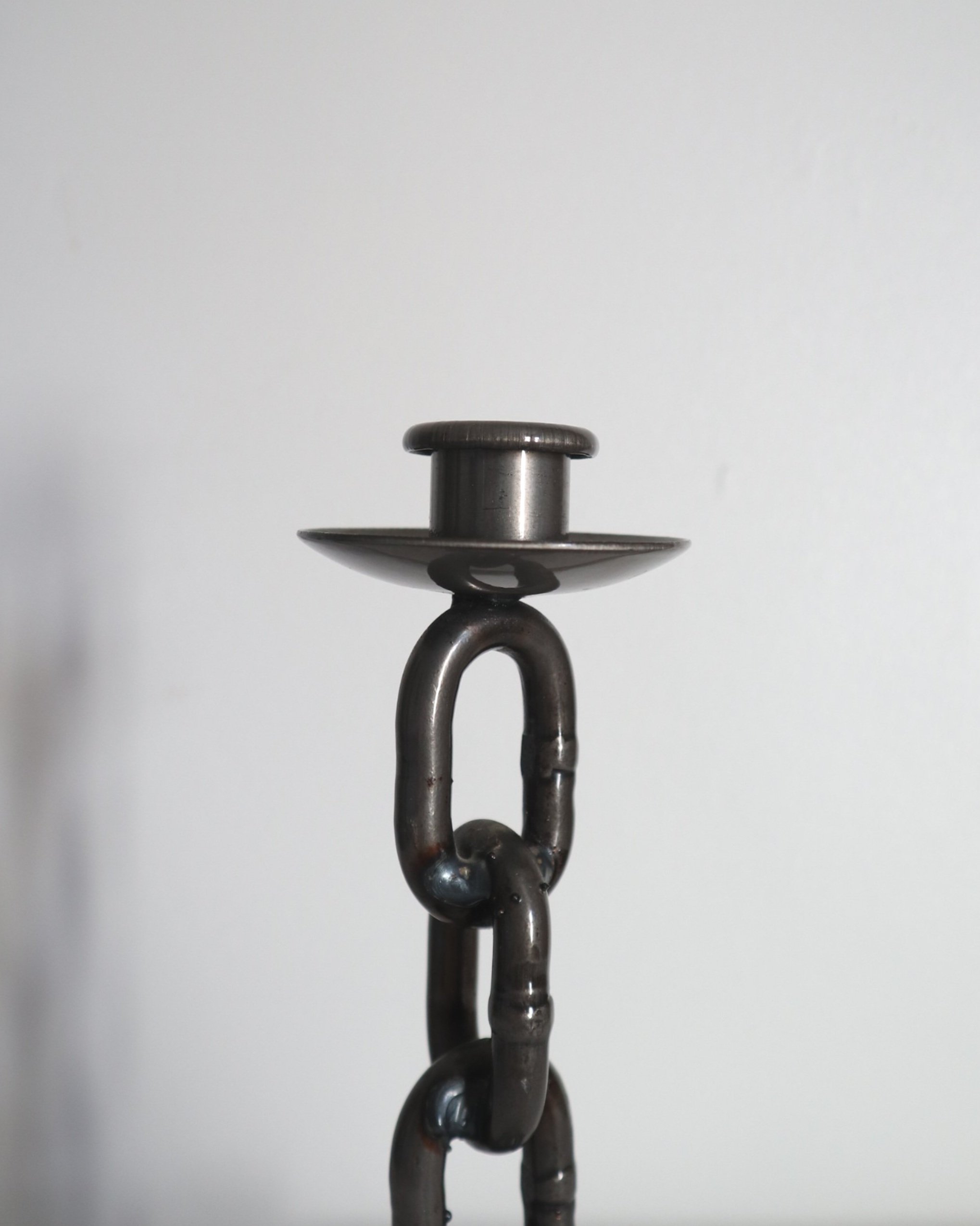 Heavy, vintage Brutalist chain link candlestick made from lacquered grey forged iron.