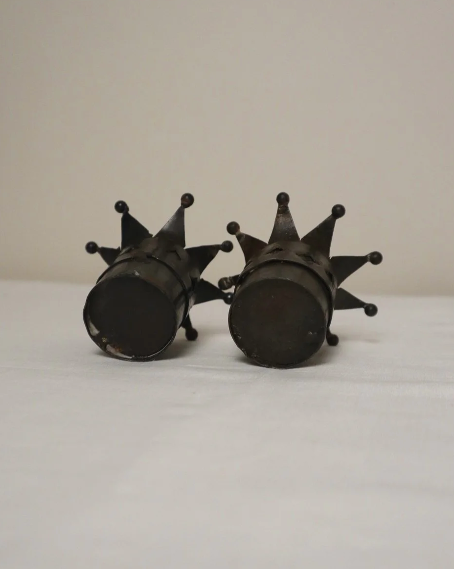 Pair of Modernist style, small dark metal jester hat or crown shaped tea light holders with diamond cut outs.