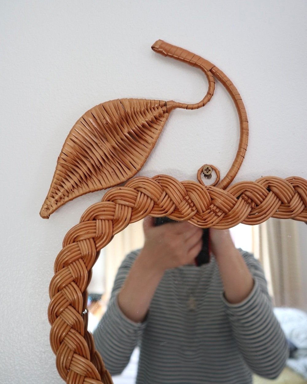 Pair of vintage small wall mirrors in the shape of an apple and a pear, with woven wicker frames.