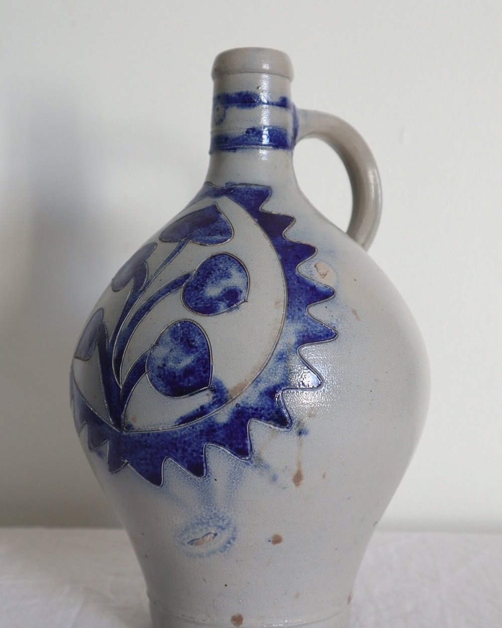 Large vintage German Westerwald salt glazed stoneware flagon with cobalt blue foliage decoration and two bands to the neck.