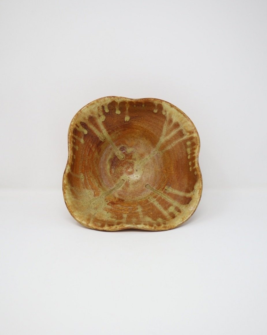 tage, handmade studio pottery ceramic bowl with wavy edge and brown, orange and ochre glaze. Marked Baughan 1997 to base.