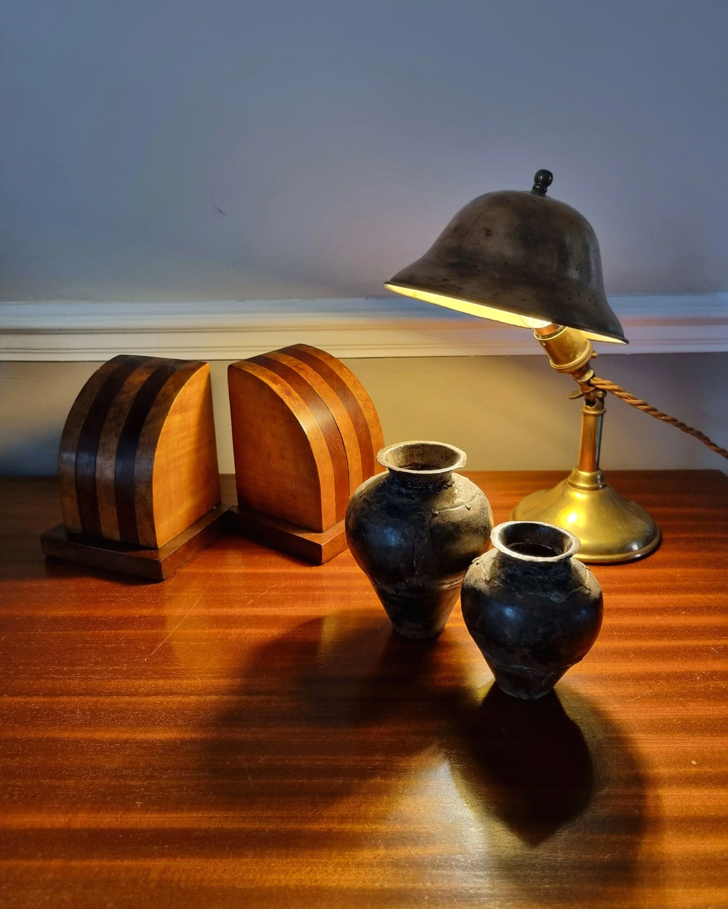 Small, vintage adjustable brass worker's desk lamp.