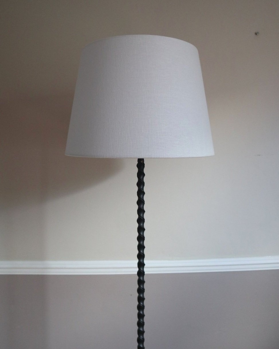 French wrought iron floor lamp with twisted corkscrew column and tripod base. Circa 1950s.