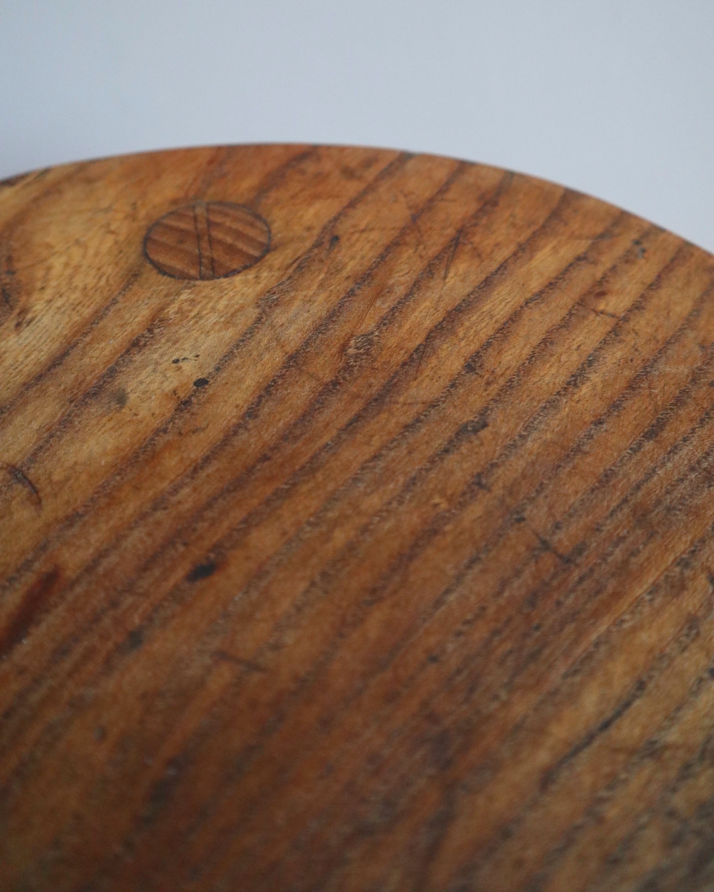Vintage rustic handmade warm wooden tripod stool with carved legs. Stamped 'John Chapman Woodcrafts Northwood'.