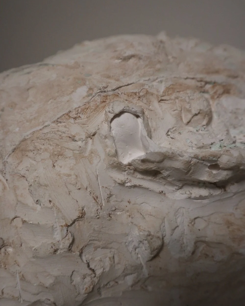 Large, heavy off white textured plaster sculpture of man's head in abstract style. Unknown age.