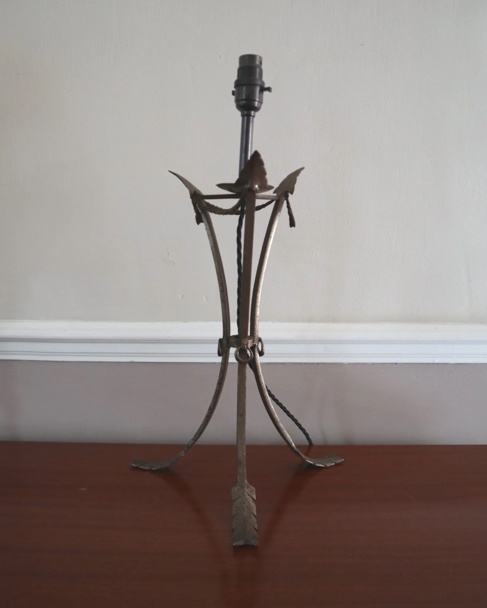 Pair of French style mid century metal tripod table lamps featuring three arrows.