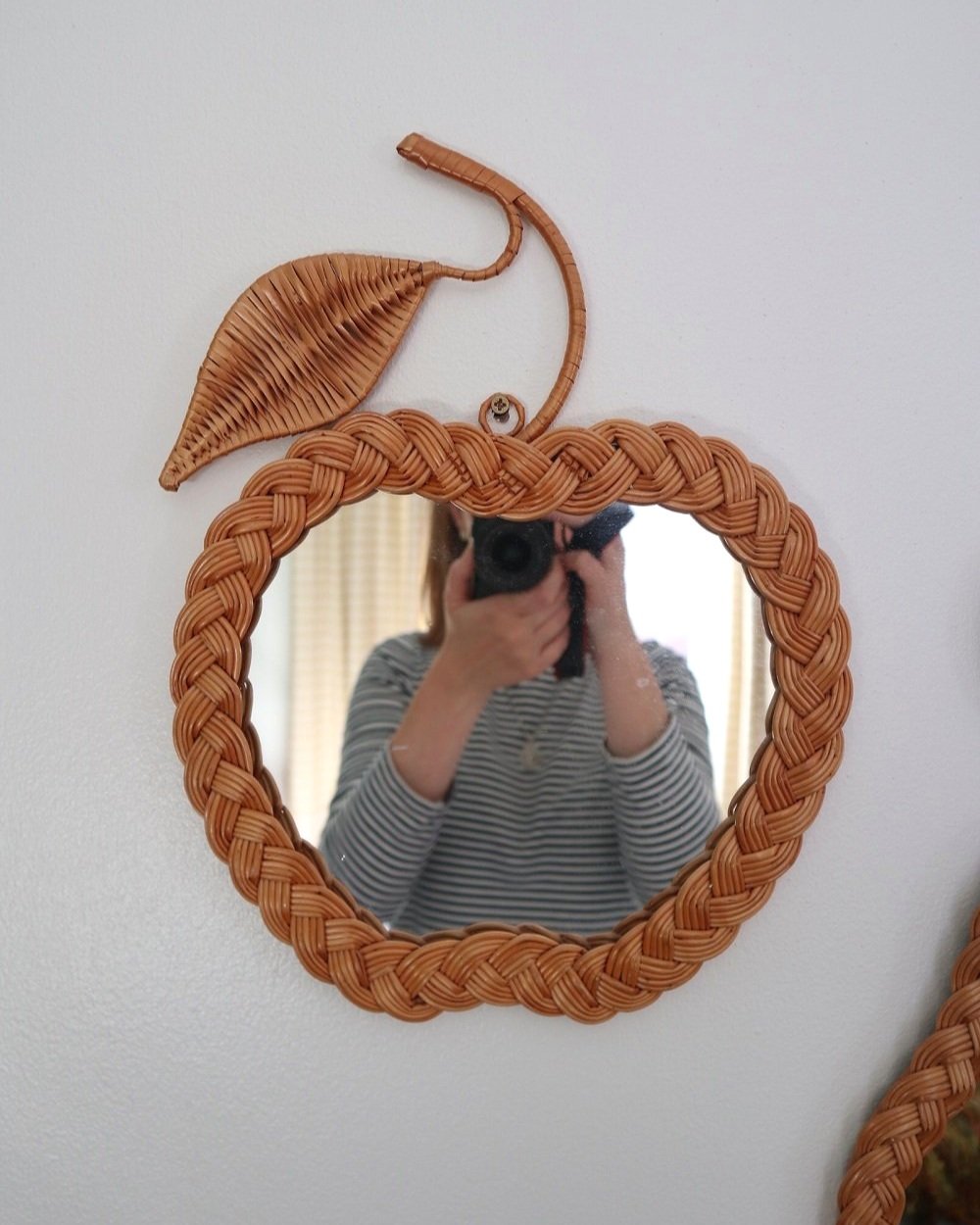 Pair of vintage small wall mirrors in the shape of an apple and a pear, with woven wicker frames.