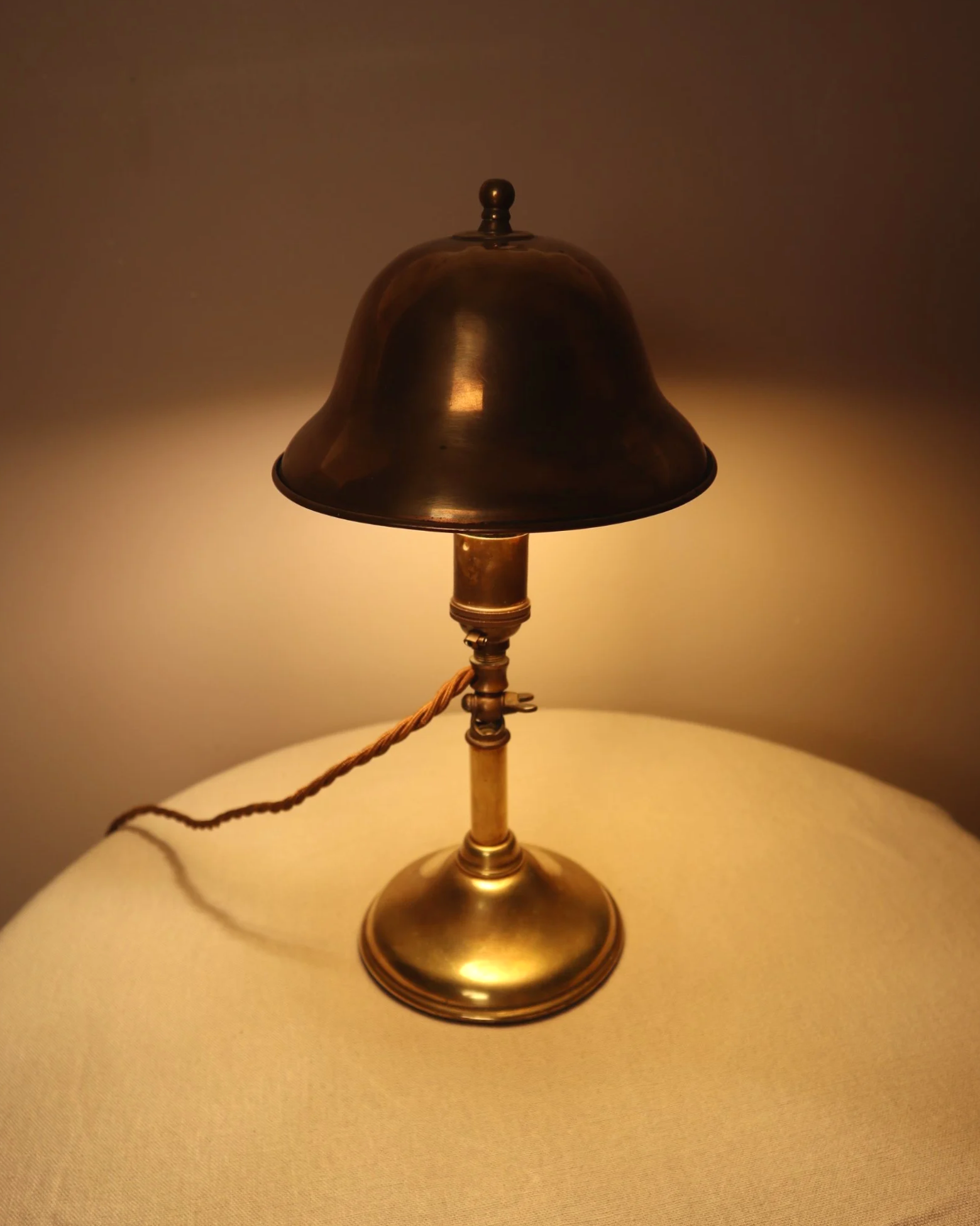Small, vintage adjustable brass worker's desk lamp. Can be freestanding or attached to the edge of a workbench etc with clamp.