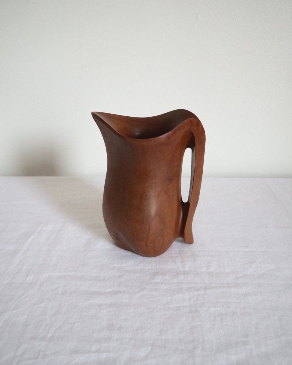 Small sculptural hand carved dark olivewood monoxyl pitcher, circa 1960/70s. In the manner of Alexandre Noll. Unsigned.