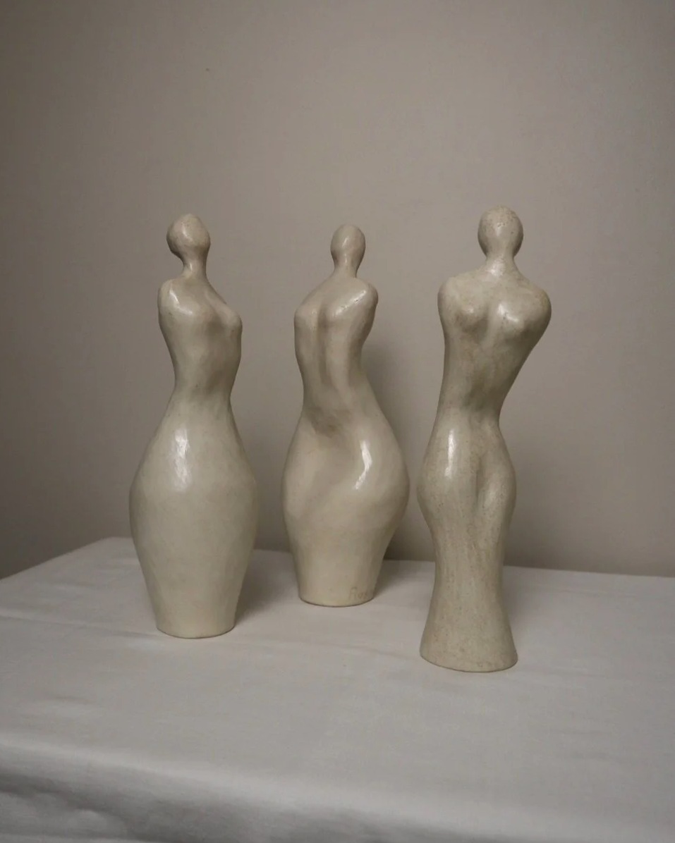 Set of three white ceramic abstract sculptures in the shape of the female form. Unknown age.  Signed 'R W Art / RoseWood Art'