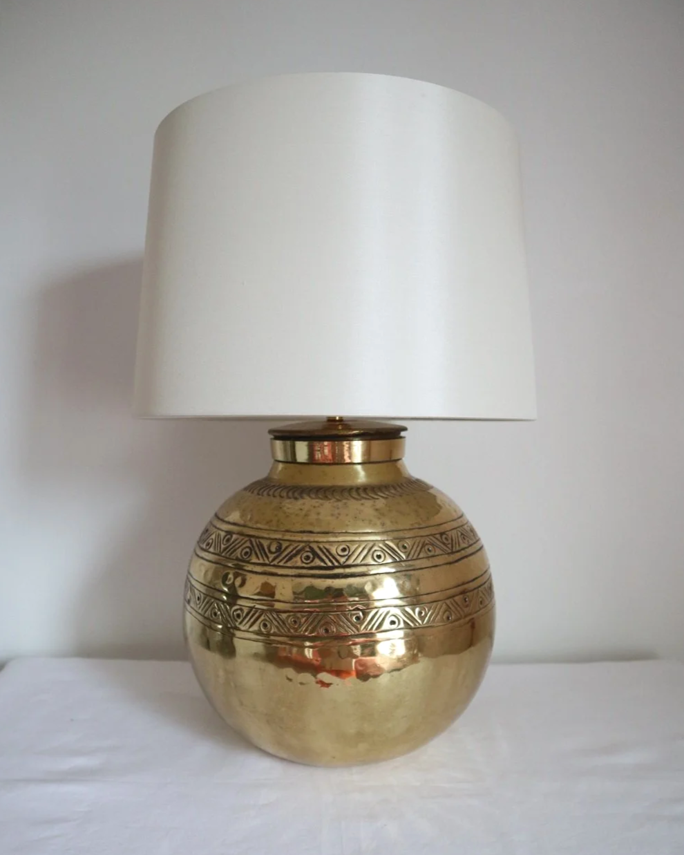 Pair of large, vintage beaten brass spherical table lamps with etched decoration.