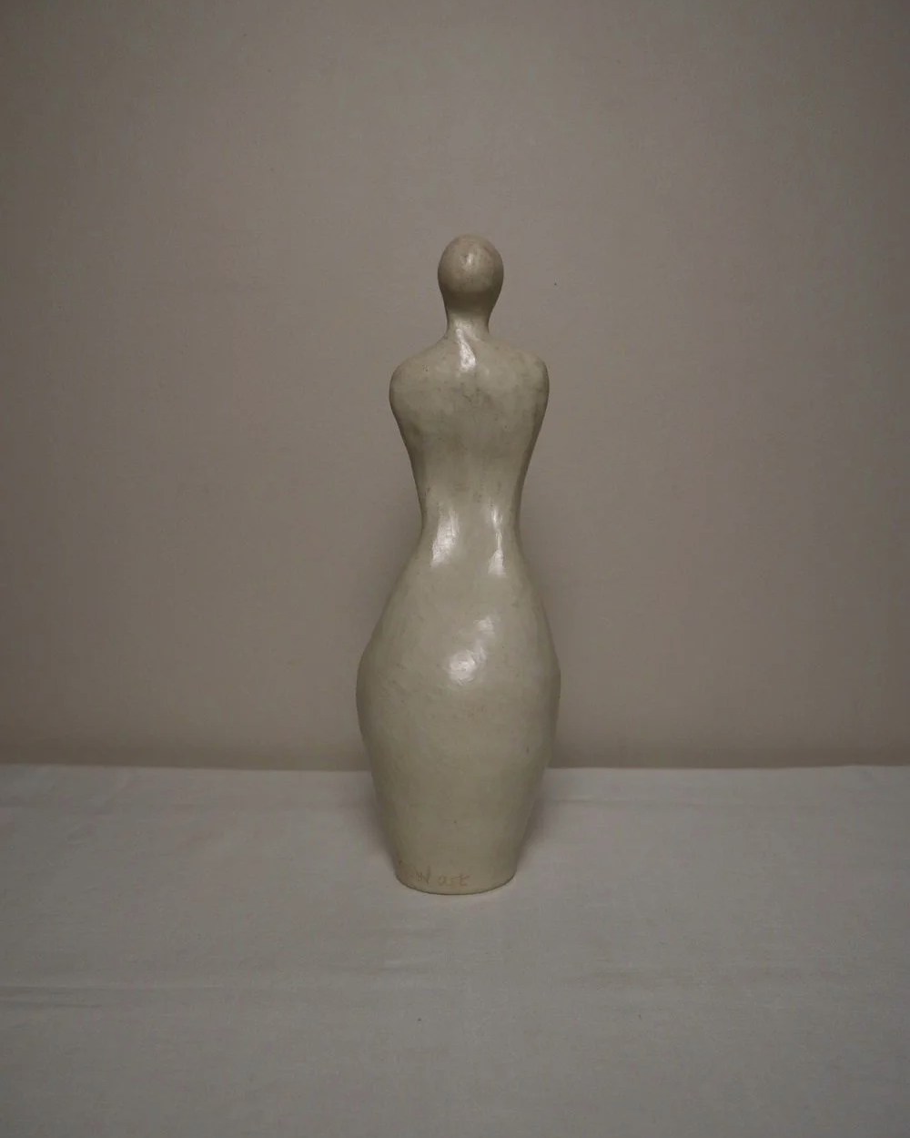 Set of three white ceramic abstract sculptures in the shape of the female form. Unknown age.  Signed 'R W Art / RoseWood Art'