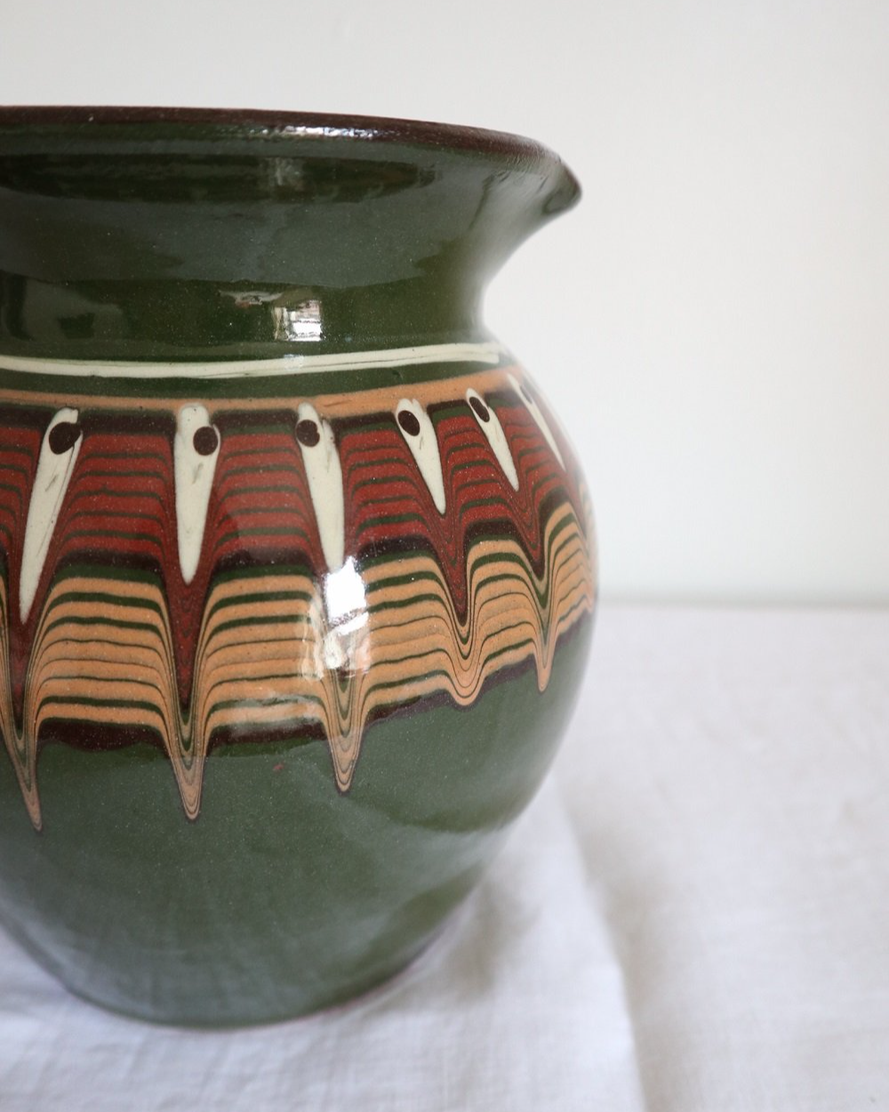 Large Bulgarian green and brown ceramic pitcher jug in traditional Troyan style.